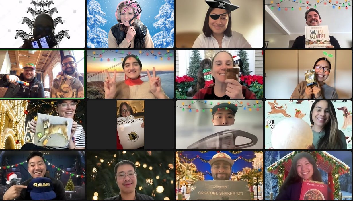 Zoom grid view of Zealots holding up gifts from a holiday gift exchange